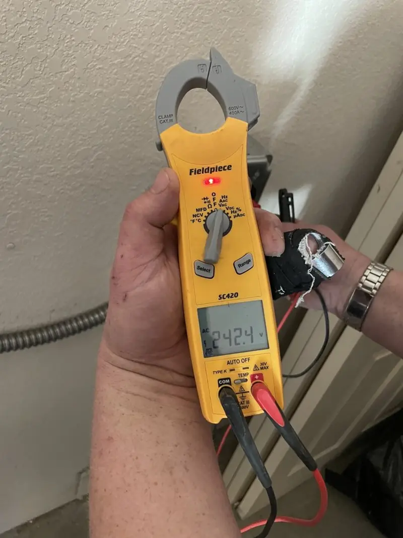 Voltage testing with clamp meter during Electrical Installation Services in Titusville